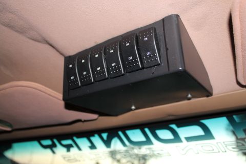 1990 Ford Bronco - An aftermarket overhead switch panel with six toggle switches is installed in the vehicle's interior.