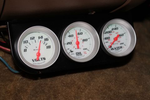 1990 Ford Bronco - A set of three Equus gauges, including voltage, oil pressure, and water temperature, are visible in the vehicle's interior.