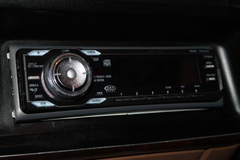 1990 Ford Bronco - Aftermarket car stereo head unit with CD player, SAT radio, and USB input.