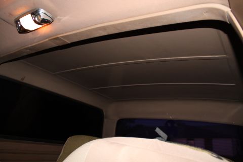 1990 Ford Bronco - The interior ceiling of a vehicle shows a dome light and a sunroof panel.