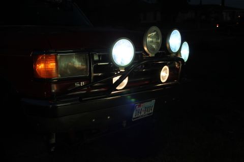 1990 Ford Bronco - Front view of a 1990 Ford Bronco, equipped with auxiliary lights and a "5.8" badge, illuminated at night.
