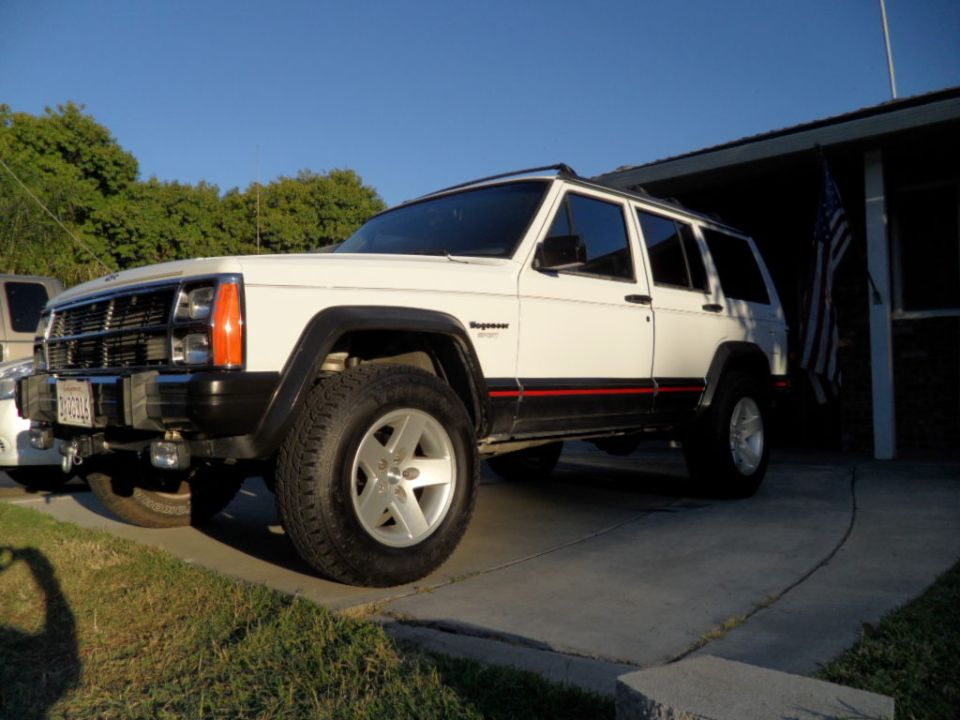 White 1994 Jeep Cherokee with red stripe, 3/4 front view