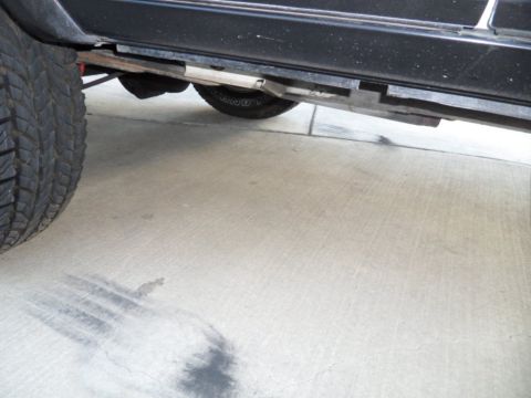 1994 Jeep Cherokee - Undercarriage detail of a 1994 Jeep Cherokee, focusing on the side panel and tire.