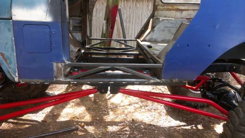 1978 Ford Bronco - Custom suspension and chassis work on a blue off-road vehicle.