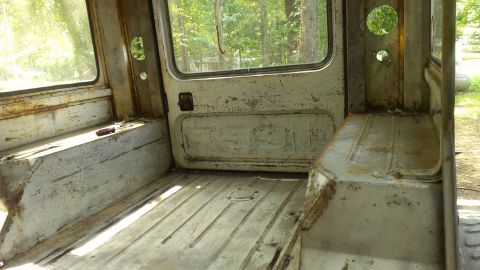 1978 Ford Bronco - Interior of a weathered utility vehicle, showing the cargo area and seating.