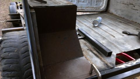 1978 Ford Bronco - Vehicle interior showing ongoing metalwork and a large tire. The year is not discernible.