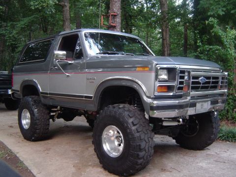 1986 Ford Bronco - This lifted Ford Bronco has a two-tone gray paint scheme and aggressive off-road tires.