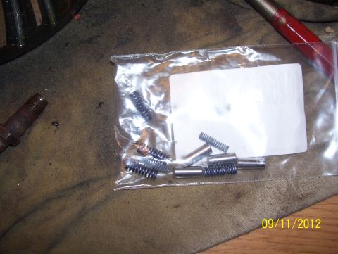 1990 Ford Bronco - Small metal parts and springs are shown in a plastic bag on a workbench, with a date stamp of 09/11/2012.