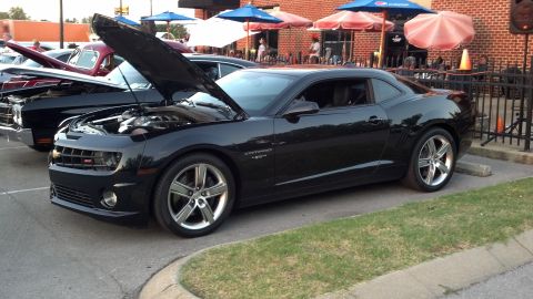2007 Ford Mustang - A black Chevrolet Camaro, likely a 2010 model, is displayed with its hood open at an outdoor event.