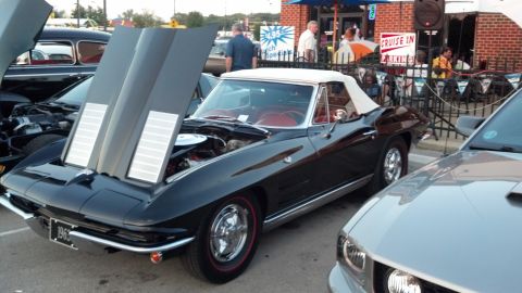 2007 Ford Mustang - A black 1966 convertible Corvette is displayed with its hood open, revealing the engine compartment.