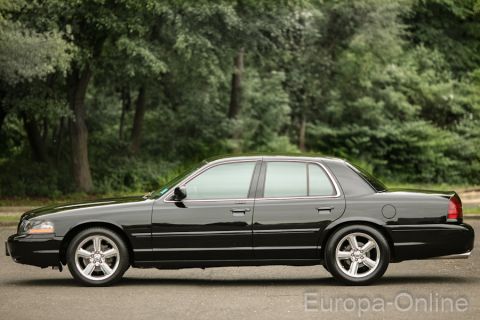 2003 Mercury Marauder - Side profile of a black 2003 Mercury Marauder sedan parked outdoors.