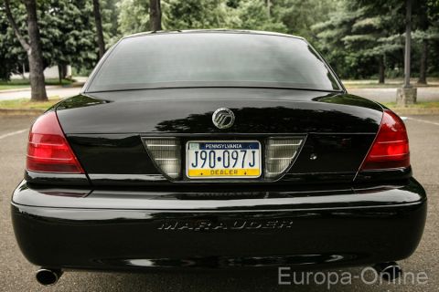 2003 Mercury Marauder - The rear of a black Mercury Marauder sedan is shown, its distinctive taillights and 'Marauder' badging.