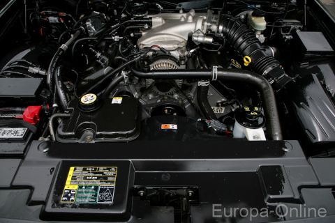 2003 Mercury Marauder - The engine bay of a 2003 Mercury Marauder is depicted, revealing its V8 engine and associated components.