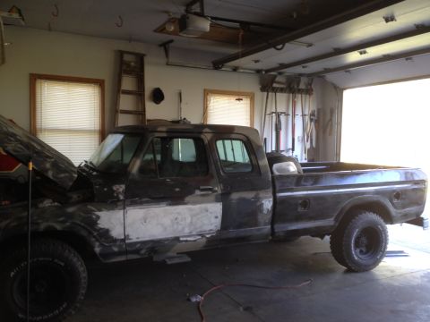 1979 Ford F-350 - A 1979 Ford F-350 truck is parked in a garage with its hood open, showing signs of bodywork.