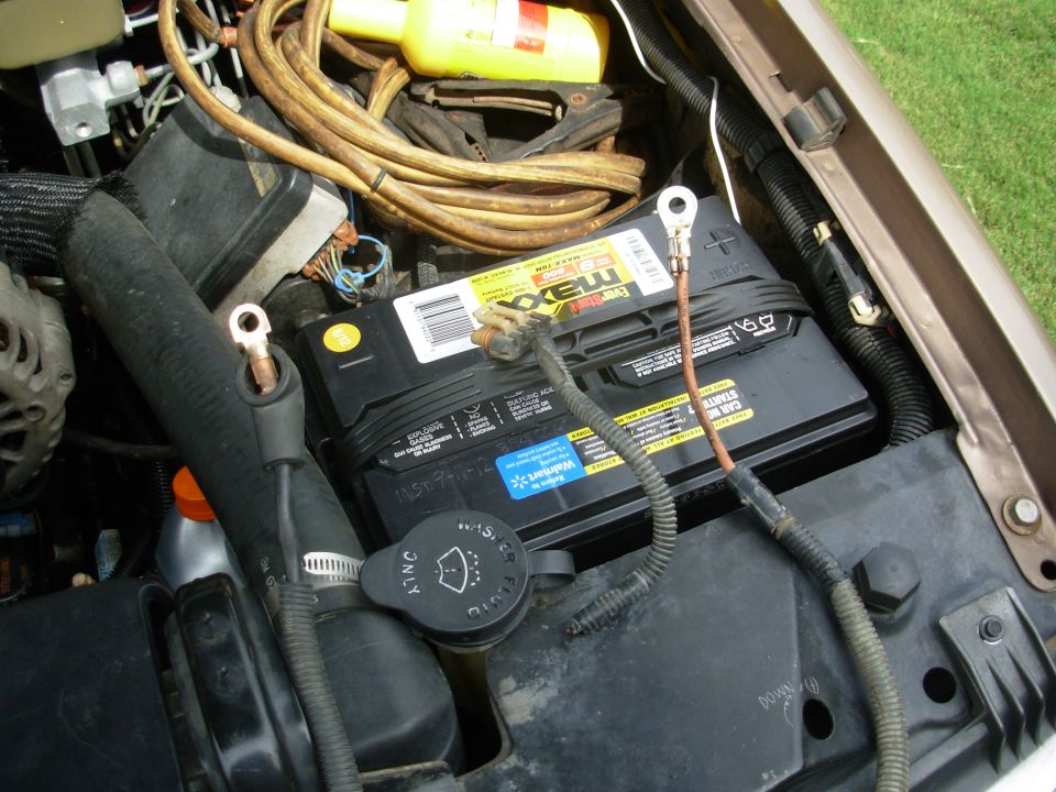 Engine bay with EverStart Maxx battery, cables, and brake fluid reservoir cap