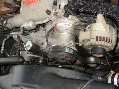 1997 Chevrolet Silverado 3500 - This is the steel prototype bracket fully installed & working, with the engine idling. The 2 bolts for the original hose hook fit under the…