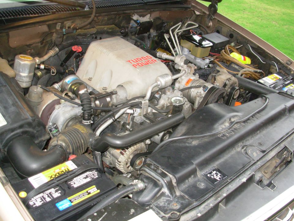 Diesel V8 engine bay with red TURBO POWER lettering on white intake cover