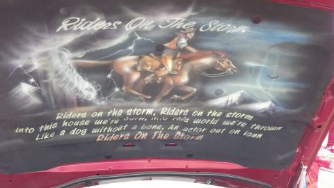 2007 Ford Mustang - Custom airbrushed hood liner features a cowboy riding a horse through a stormy landscape with text.