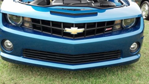2007 Ford Mustang - This blue Chevrolet Camaro features a prominent grille with the SS badge, indicating its sporty trim level.
