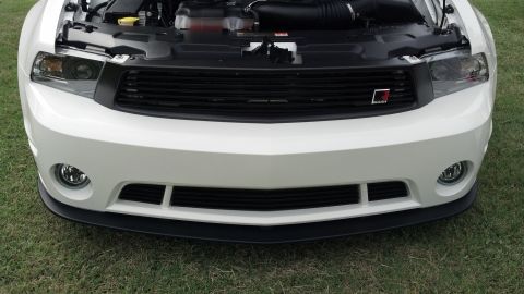 2007 Ford Mustang - Front view of a white 2010-2012 Ford Mustang with the hood open, showing the engine bay.