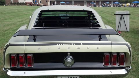 2007 Ford Mustang - The rear of a classic Ford Mustang Mach 1 is visible, louvers and a spoiler.