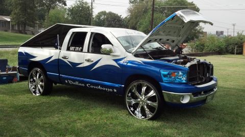 2007 Ford Mustang - Customized pickup truck with Dallas Cowboys graphics and large chrome wheels.