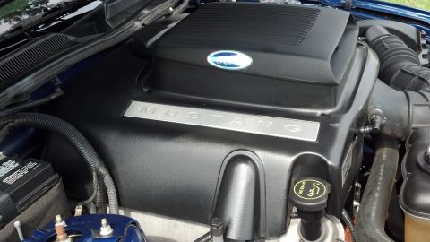 2007 Ford Mustang - Engine bay detail of a 2007 Ford Mustang, showing the engine cover with "Mustang" lettering.
