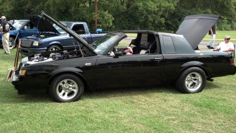 2007 Ford Mustang - Modified black Buick Grand National on display with its hood and trunk open.