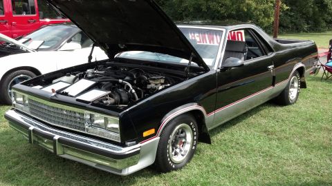 2007 Ford Mustang - This black El Camino, likely from the early 1980s, is displayed with its hood open, revealing the engine bay.