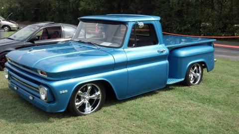 2007 Ford Mustang - A classic blue pickup truck with custom wheels sits on a grassy lawn, with another vehicle in the background.