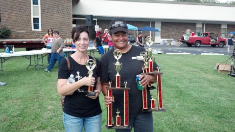 2007 Ford Mustang - Two smiling women proudly display their trophies after an event.