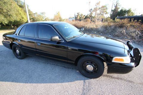 2004 Ford Crown Victoria - Black 2004 Ford Crown Victoria sedan parked on asphalt with a push bar on the front.