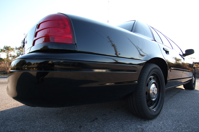 Black 2004 Ford Crown Victoria rear quarter view