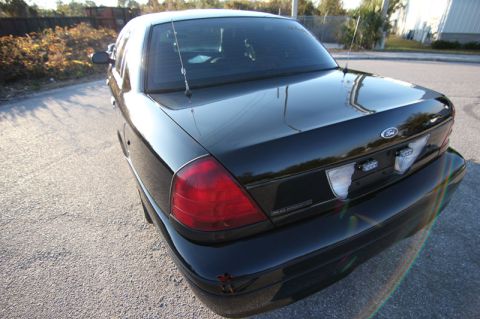2004 Ford Crown Victoria - Rear view of a black Ford Crown Victoria sedan parked on asphalt.