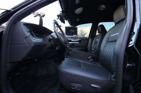 2004 Ford Crown Victoria - Interior view of a police vehicle equipped with a laptop and shotgun mount.