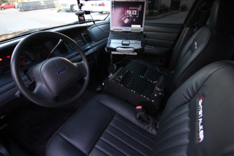2004 Ford Crown Victoria - Interior view of a 2004 Ford Crown Victoria police car equipped with a laptop and communication gear.