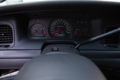 2004 Ford Crown Victoria - Interior view of a 2004 Ford Crown Victoria dashboard, showing the instrument cluster and steering wheel.