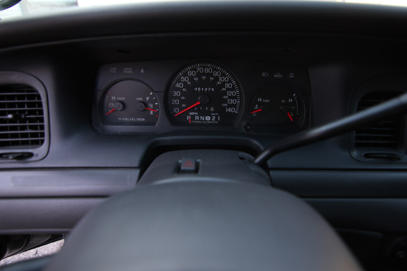 2004 Ford Crown Victoria dashboard with speedometer, tachometer, fuel gauge, and odometer showing 081275
