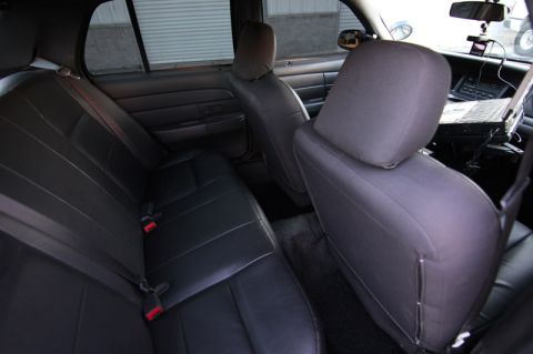 2004 Ford Crown Victoria - The interior of a 2004 Ford Crown Victoria, rear seating and a laptop mounted on the dashboard.