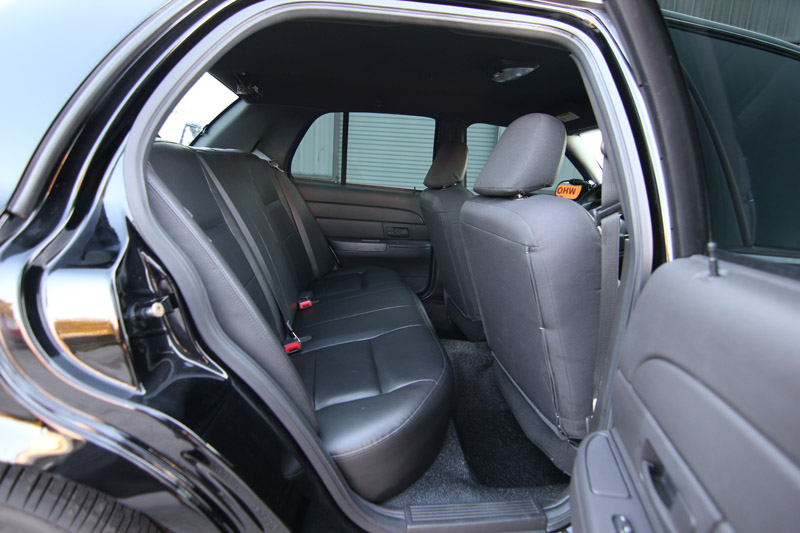 Back seat and interior of a black Ford Crown Victoria