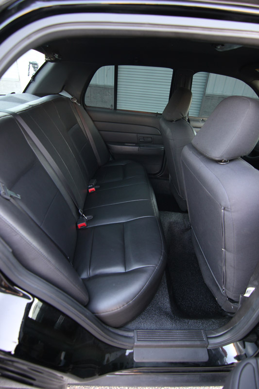 Black leather rear seats and door panel inside a car