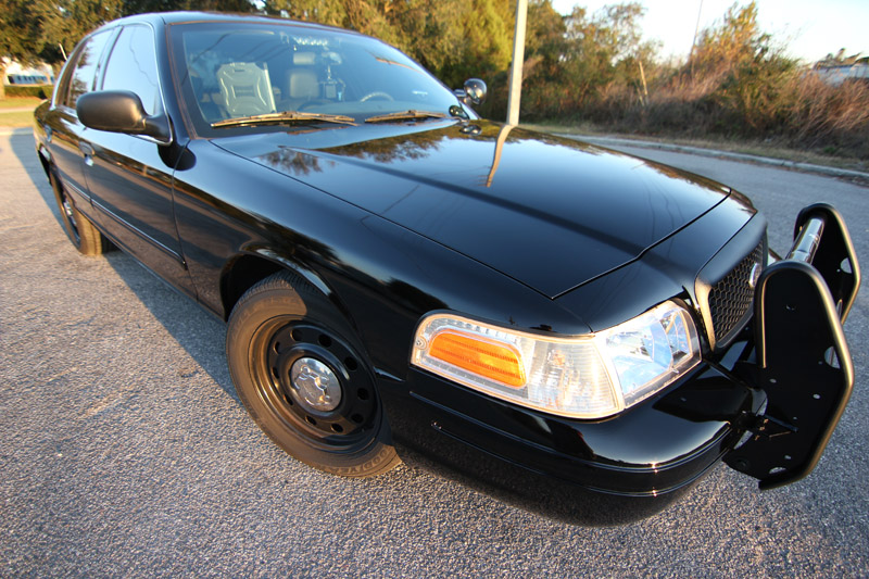 Black 2004 Ford Crown Victoria police car front 3/4 view with push bumper
