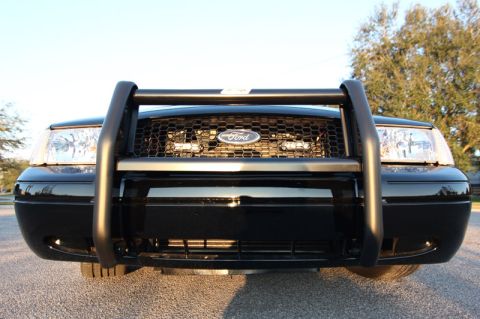 2004 Ford Crown Victoria - Front view of a 2004 Ford Crown Victoria police interceptor with a push bar.