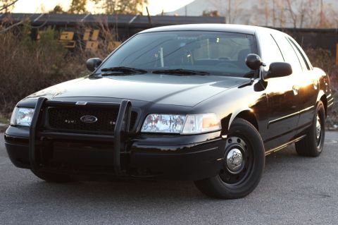 2004 Ford Crown Victoria - This black 2004 Ford Crown Victoria Police Interceptor is shown with a push bumper and steel wheels.