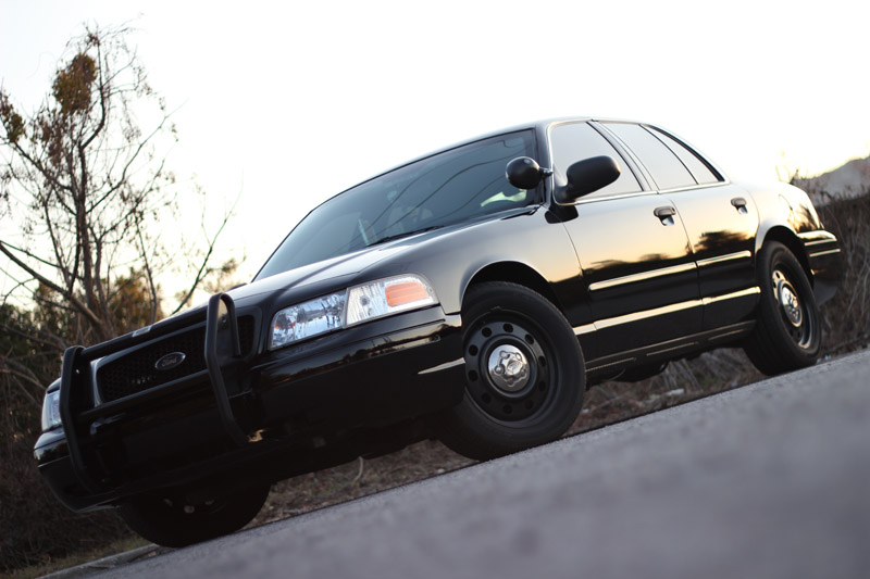 Black Ford Crown Victoria P71 with push bumper, seen from a low angle