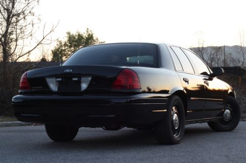 2004 Ford Crown Victoria - Rear view of a black Ford Crown Victoria sedan parked outdoors during the day.