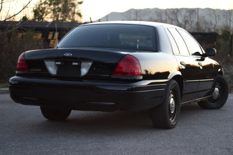 2004 Ford Crown Victoria - Rear view of a black 2004 Ford Crown Victoria parked on asphalt.