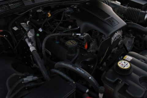 2004 Ford Crown Victoria - Detailed view of the engine bay in a 2004 Ford Crown Victoria, highlighting various mechanical parts and systems.