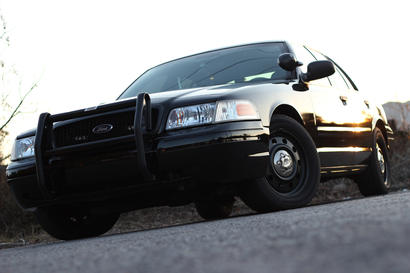 Black 2004 Ford Crown Victoria with push bar, front view, parked on asphalt