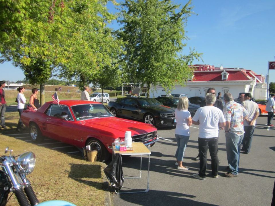 Red 1967 Ford Mustang coupe with American flag, 3q front view